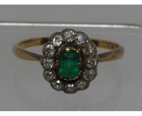 Emerald and diamond oval cluster ring.  Ring size R&1/2.  Approx weight 3.5 grams.(B.P. 21% + VAT) 