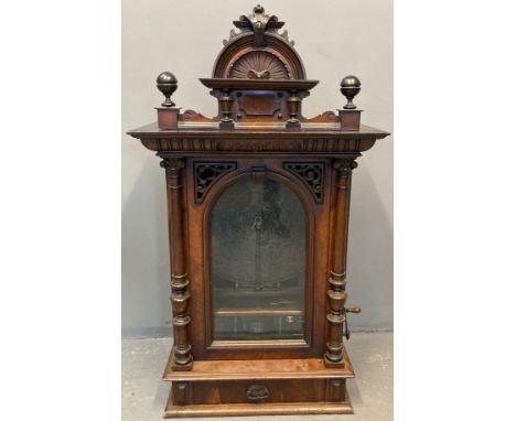 Late Victorian walnut 'penny-in-the-slot' Polyphon, the architectural pediment with turned finials and shell decoration above