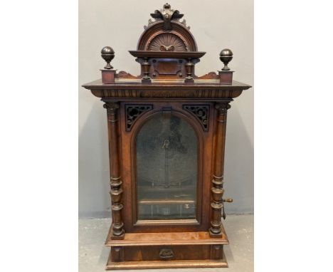 Late Victorian walnut 'penny-in-the-slot' Polyphon, the architectural pediment with turned finials and shell decoration above