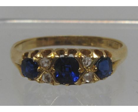 Sapphire and diamond ring set in 18ct gold.  The three sapphires separated by rose cut diamonds.  Ring size Q.  Approx weight