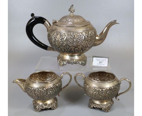 Three piece Indian Silver tea service comprising: bullet shaped teapot with ebonised turned handle, two handled sucrier and a