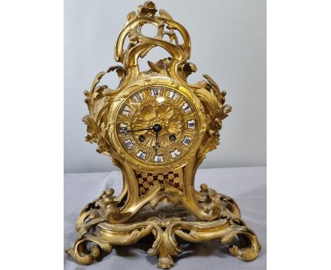 Late 19th century French ormolu rococo style balloon shaped mantle clock, overall decorated with scrolled openwork, gilded sh