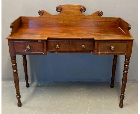 19th century mahogany ladies dressing table, the shaped gallery top with moulded roundels above a shaped top with three cock 