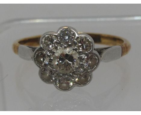 Diamond daisy cluster ring set in 18ct gold and platinum.  Ring size R&1/2.  Approx weight 3.4 grams.(B.P. 21% + VAT) 