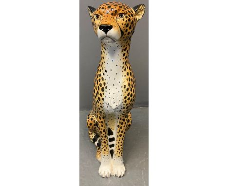 Modern ceramic handpainted study of a cheetah with naturalistic features, in seated pose.  Probably continental.  82cm high a