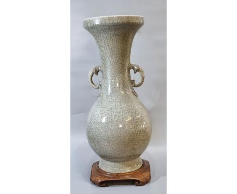 Large Chinese celadon stoneware baluster vase on an crackle glaze ground with elephant mask ring handles on a ornately carved