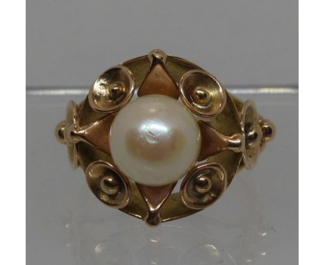 Cultured pearl ring in decorative yellow metal setting.  Ring size L.  Approx weight 6.3 grams.  (B.P. 21% + VAT) Tests as 18