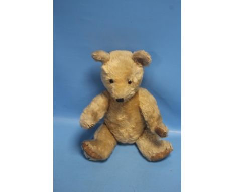 A VINTAGE JOINTED TEDDY BEAR with stitched nose and button eyes