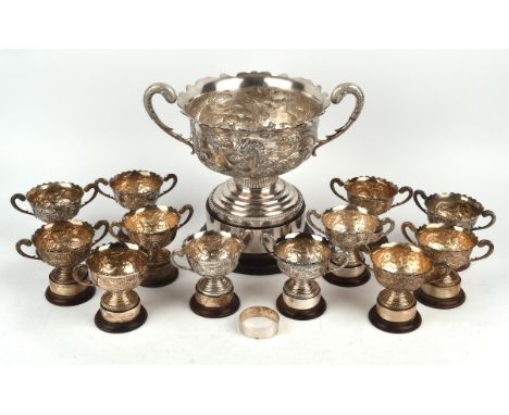 Large Chinese silver two handled pedestal bowl embossed with two four toed dragons amongst clouds, signed LC Ltd Sterling (LE
