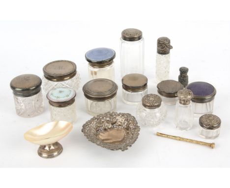 An enamelled silver topped dressing table jar, indistinctly hallmarked, eight further glass dressing table jars with silver l
