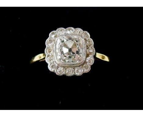 An antique 18 carat gold and platinum ring set cushion cut diamond (approx 3/4 carat) in diamond surround