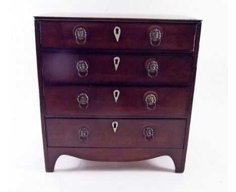 An early 19th century mahogany apprentice chest with four drawers inlaid bone escutcheons, all on swept supports 
