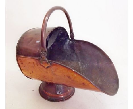A 19th century copper helmet form coal scuttle