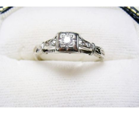 A 14 carat white gold ring set diamond on diamond set shoulders