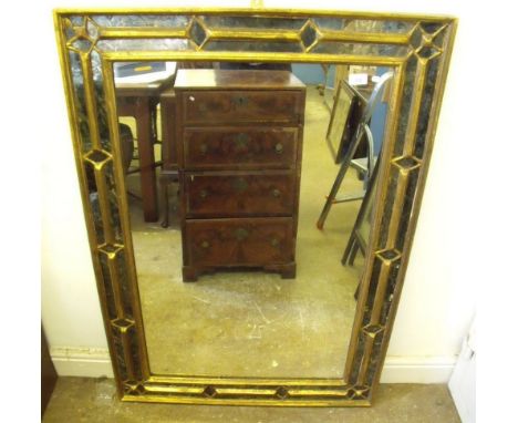 A black and gilt rectangular mirror with decorative surround - 116 x 80cm