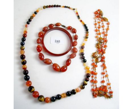 A selection of cornelian beads and a bangle