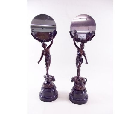 A pair of circular dressing table mirrors on bronze finish classical figure and lion supports