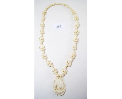 An early 20th century carved bone necklace decorated elephants 