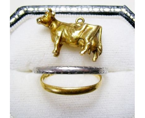 A 9 carat gold cow charm .5g, &nbsp;a platinum ring 2.5g&nbsp;and another ring