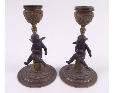 A pair of 19th century small gilt metal and bronze putti form candlesticks, 11.5 cm
