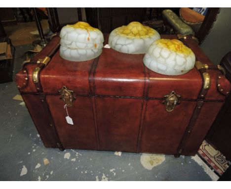 A leather and brass bound steamer trunk. H 60cm W 92cm D 90cm.