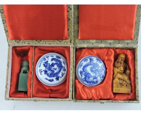 A small jade seal, carved as a lion, together with a soapstone seal, carved as a wise elder, each boxed with lidded ink dish 