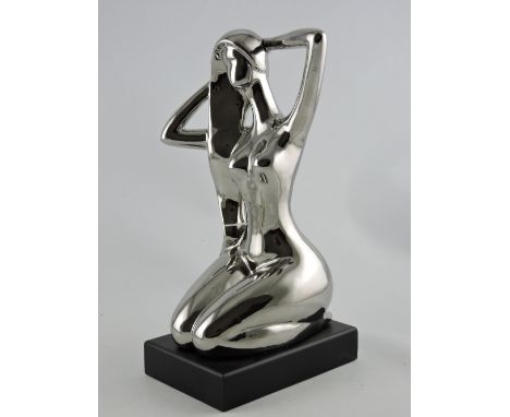A ceramic figure of an Art Deco lady on stand