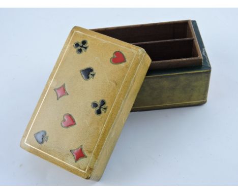A rectangular leather clad playing card box. The lid decorated with all four suits.