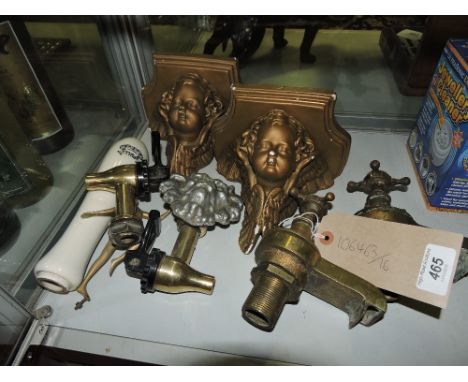 A pair of late Victorian brass taps, together with a pair of wall plinths on cherub heads, other metalware and a ceramic pull