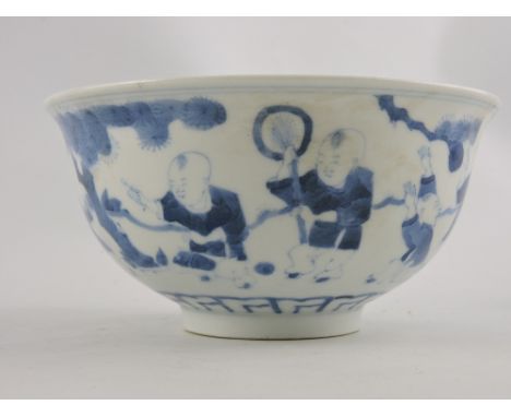 A Chinese blue and white bowl decorated with children playing in a courtyard scene. H 8cm D 15cm