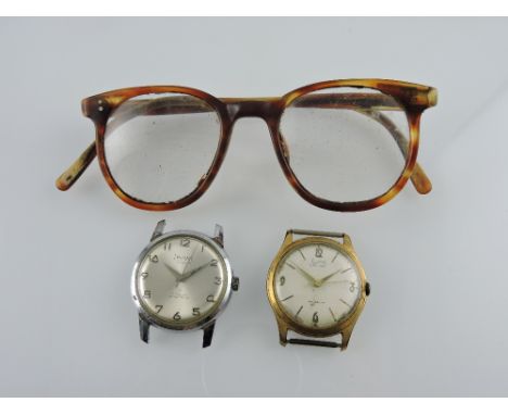 Two vintage gents' wristwatch heads, together with a pair of faux tortoiseshell spectacles of similar age (3)
