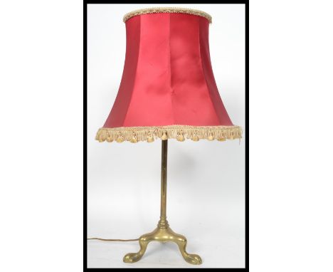 A 19th century Victorian brass tripod table lamp raised on three claw feet. Measures 55 cm high.