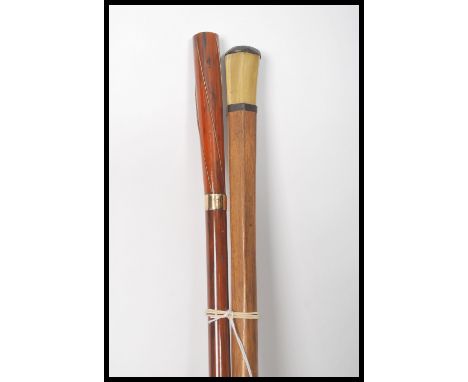 A pair of early 20th century Edwardian walking stick canes one having a tapering bamboo shaft with 9ct gold (unmarked but mak