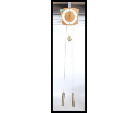 A retro 20th century Danish inspired brass weight and chain driven wall clock the body of the clock with a teak finish. Measu