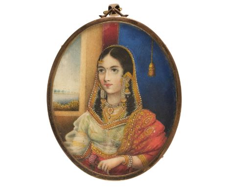 * Indian School. Portrait of a lady, mid 19th century, watercolour and gouache on ivory, oval half-length portrait of a seate