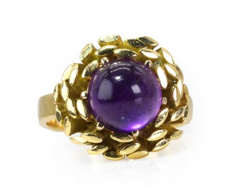 An 18ct gold amethyst ring by John Donald, c.1989,  modelled as a stylised flower head or nest, centrally set with a circular