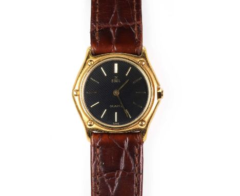 An 18ct gold ladies' Ebel quartz strap watch,  a circular bezel within a tonneau-shaped case, 26mm diameter, black guilloche 