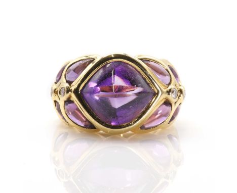 An 18ct gold amethyst and diamond ring retailed by David Morris, c.1990,  centred by a rub set two sided amethyst cabochon. T