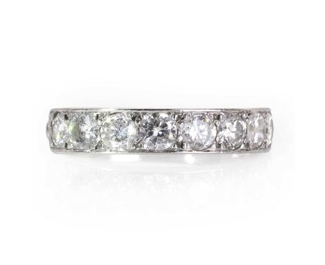 A diamond half eternity ring,  the flat profile head bead set with eight round brilliant cut diamonds, the combined weight es