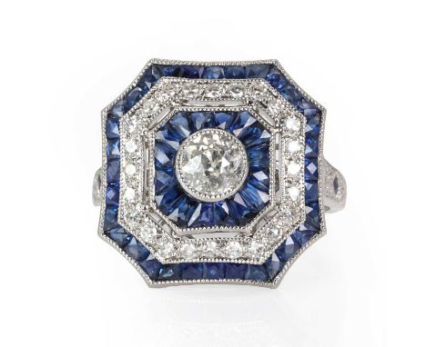 An Art Deco style sapphire and diamond target cluster ring,  of octagonal fluted form, with an old European diamond rub set t
