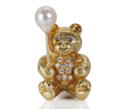 An 18ct gold cultured pearl, sapphire and diamond teddy bear brooch, the textured smiling teddy bear with round sapphire cabo