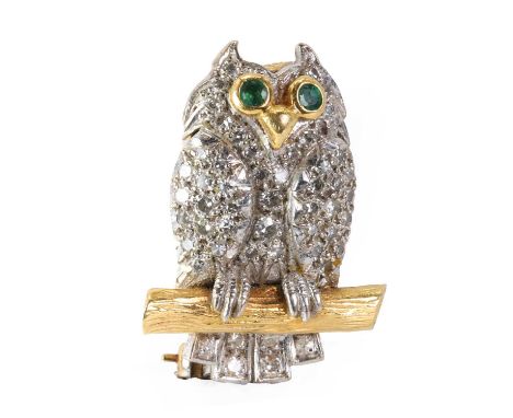 A two colour gold diamond and emerald novelty brooch, in the form of an owl pavé set in white gold with round cut diamonds, w