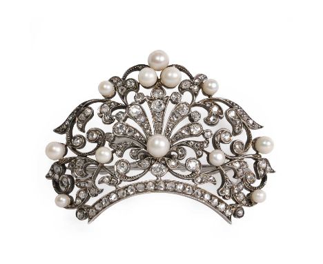 A pearl and diamond openwork foliate design brooch, c.1900,  with graduated pearls, untested, to a pierced scrollwork mount s
