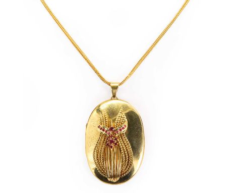 An 18ct gold ruby locket pendant, the large oval locket with front scroll detailing, decorated with small rubies, the reverse
