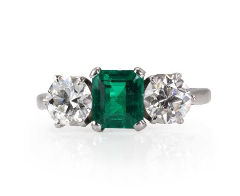 An emerald and diamond three stone ring,  with an emerald cut emerald, estimated as 0.94ct, with an old European cut diamond 