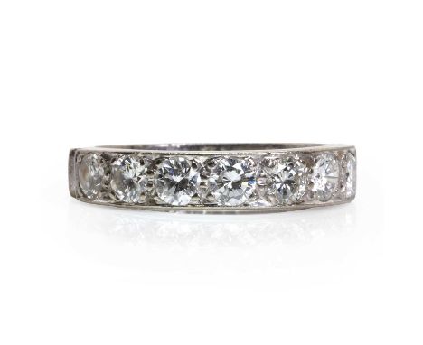 An 18ct white gold half eternity ring,  with seven round brilliant cut diamonds, with a combined weight estimated as 0.84ct, 