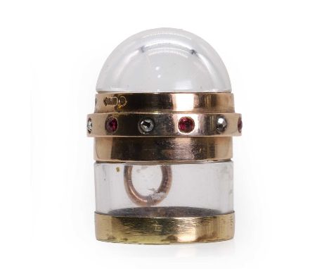 A 9ct gold mounted glass pill box,  of cylindrical form, the clear glass body mounted in 9ct rose gold. The domed hinged lid 