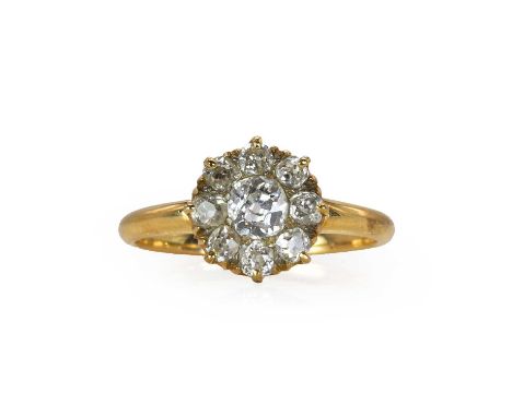 An old cut diamond daisy cluster ring, c.1900,  centred with an old mine diamond encircled by smaller old cut diamonds, all c