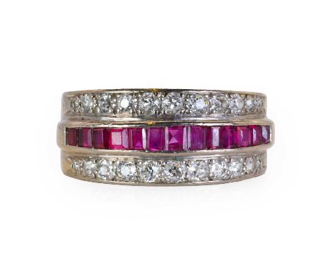 A white gold ruby and diamond three row dress ring,  with a channel line of graduating calibré cut ruby, flanked by a line of