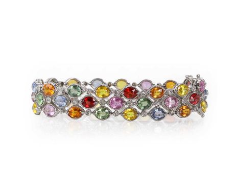 A white gold, three row varicoloured sapphire and diamond bracelet, with three rows of oval mixed cut blue, pink, green, yell